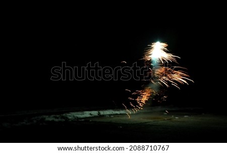 box with night explosion full of explosive pyrotechnics. white orange fireball in the shape of a white bush with lots of hot shards. Cluster bombs falling on the street bullets glowing shrapnel flames