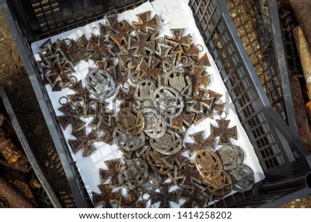 Box with old rusty World War 2 German Awards, Iron Cross and others, at flea market