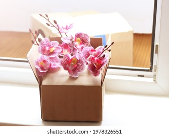 A Box Of Orchids On The Doorstep. Flower Delivery.