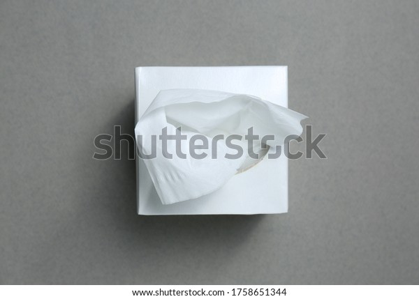 Box of\
paper tissues on grey background, top\
view
