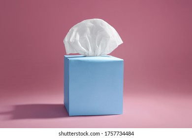 Box With Paper Tissues On Pink Background