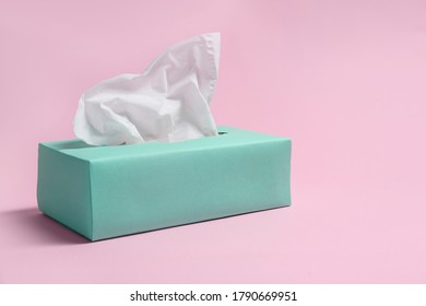 Box With Paper Tissues On Pink Background