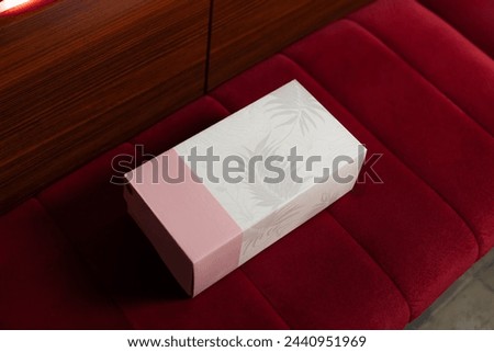 A box for plain pink and white shoes with floral motif.