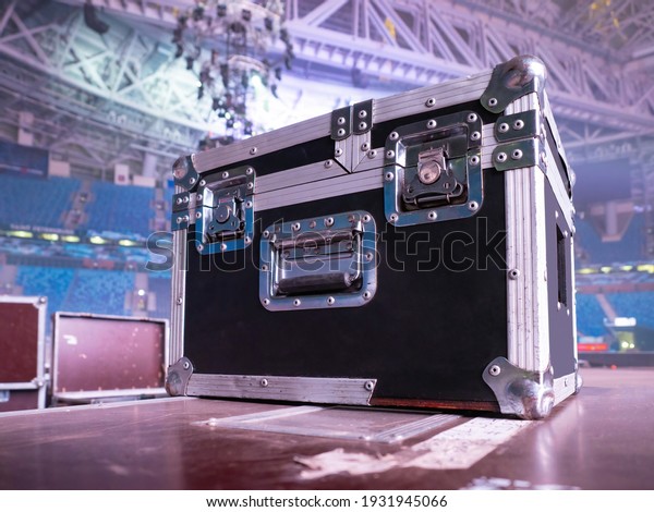 Box rack for transportation of concert\
equipment. Wardrobe trunk on background of concert venue. Rack\
wardrobe trunk on stage. Concept - sale of rack cases for concert\
equipment. Musical\
equipment