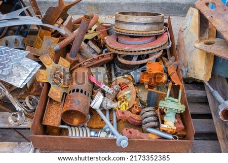 Box of scrap metal objects on table for recycling