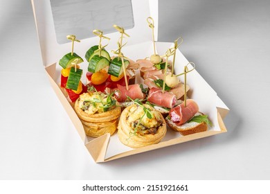 box of snacks on skewers in a cardboard box