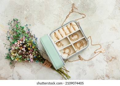 Box and stylish jewelry   bouquet beautiful flowers grunge background