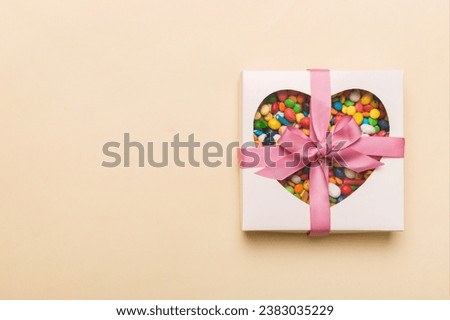 Box with sweet chocolate candies on color background, Various candy sweets. Valentines day gift box. Top view flat lay with copy space.