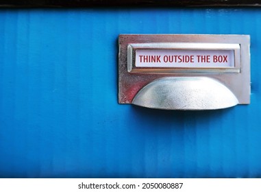 Box With Tag THINK OUTSIDE THE BOX , Concept Of Breaking Status Quo To Find Innovative Solution Or Create Something Differently, Stand Out From The Crowd.