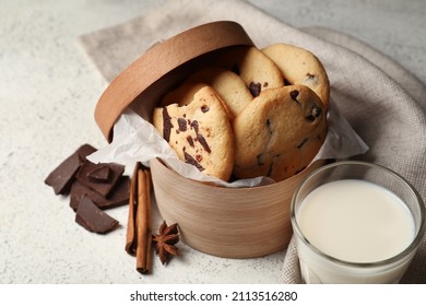 Box With Tasty Cookies, Glass Of Milk And Cinnamon On Light Background