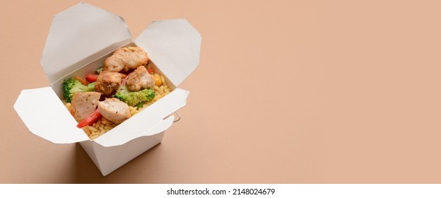 Box With Tasty Rice, Meat And Vegetables On Color Background With Space For Text. Food Delivery