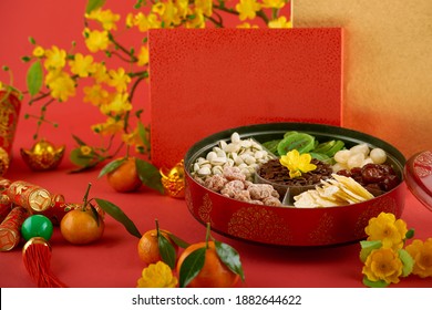 Box of traditional snacks like dried watermelon seeds, nuts and dried fruits for Chinese New Year celebration