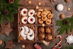 Box With Variety Of Christmas Cookies: Linzer Cookies With Strawberry Jam, Crescents With Walnuts And Sugar Powder, Almond Cookies, Chocolate Cookies With Dulce De Leche Condensed Milk.