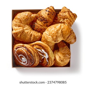 box of various freshly baked pastries isolated on white background, top view