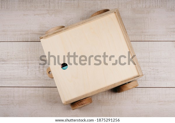 A box of wood to store\
children\'s cubes. Children\'s toys made of natural material. Wooden\
construction kit in a large box-cars made of plywood. Ecological\
material.