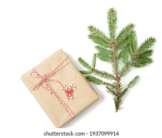 box wrapped in brown kraft paper and tied with rope, gift on white background, top view