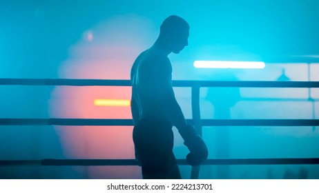 Boxer in the boxing gym. Bandages his hands. Sparring in the ring. Boxer jumping rope. Exercise with ropes. Round one. Fog in the ring. Zetsky sport. Beautiful backlight. World boxing champion.