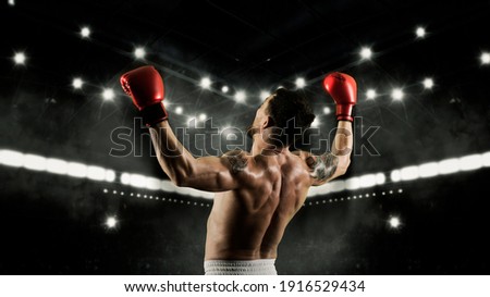 Boxer celebrating win on dark background. Sports banner. Horizontal copy space background