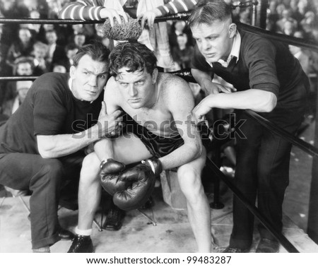 Boxer in corner with trainers
