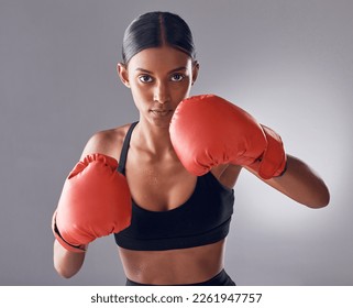 Boxer, fight and portrait of woman in studio for sports exercise, strong muscle or mma training. Indian female, boxing workout and fist gloves for impact, energy and warrior power in battle challenge - Powered by Shutterstock