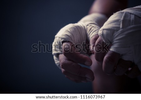 Boxer hand in darkgray background.fighting concept.copy space