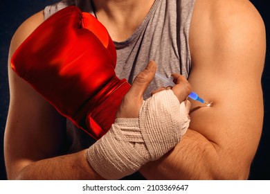 A Boxer Injects Doping Into His Arm Before A Fight. The Fighter Administers A Steroid Injection. An Unclean Athlete. Dishonest Competition.