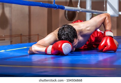 Boxer Lying Knocked Out In A Boxing Ring