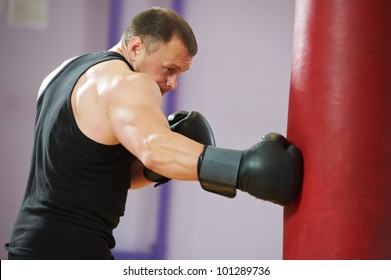 Boxer Man During Boxing Hiting Heavy Bag At Training Fitness Gym