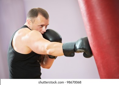 Boxer Man During Boxing Hiting Heavy Bag At Training Fitness Gym