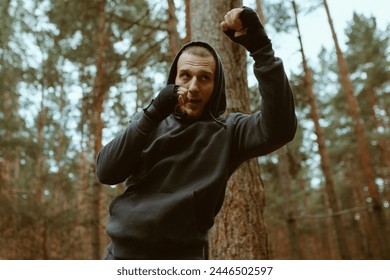 Boxer man traning in the forest. Shadow boxing. Boxer jog. Sport motivation. Outdoor training - Powered by Shutterstock