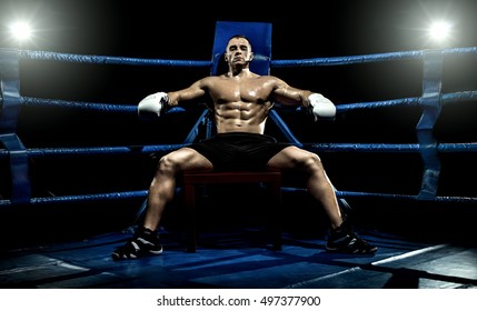 boxer on boxing ring, tired time-out,  black bacground, horizontal photo - Powered by Shutterstock