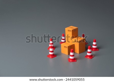 Boxes bounded by traffic cones. Cargo seizure and export restrictions. Economic impediments. Affecting economies and businesses, dependent on the uninterrupted exchange of goods