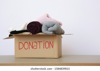 boxes with donations with necessary things on the table on a light background. Charity, volunteering.
