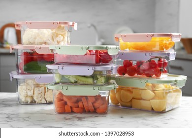 Boxes with fresh raw vegetables on table in kitchen