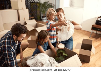 Boxes, new home and parents with children, playing and bonding together with property. Happy family, apartment and cardboard with mother, father and kids with real estate, cheerful and moving in - Powered by Shutterstock