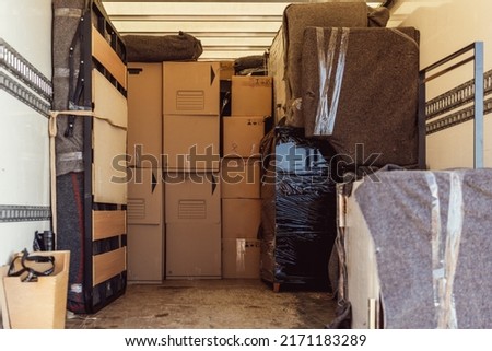 A lot of boxes and packages from a move inside a truck