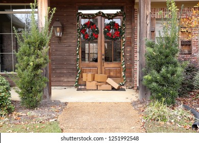 Boxes and packages next to front door during holiday christmas season. 