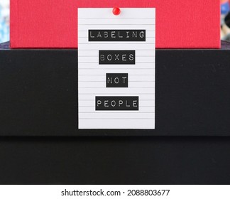 Boxes with pinned note written LABELING BOXES NOT PEOPLE , concept of avoid blaming or judging people and better understand them, stop labeling someone else on your problem - Shutterstock ID 2088803677