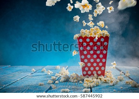 Boxes of popcorn on blue background, close-up.