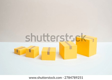 Boxes from small to large symbolizing parcels and shipment growth. Increased turnover in logistics, warehouse operations, online commerce and global delivery services.