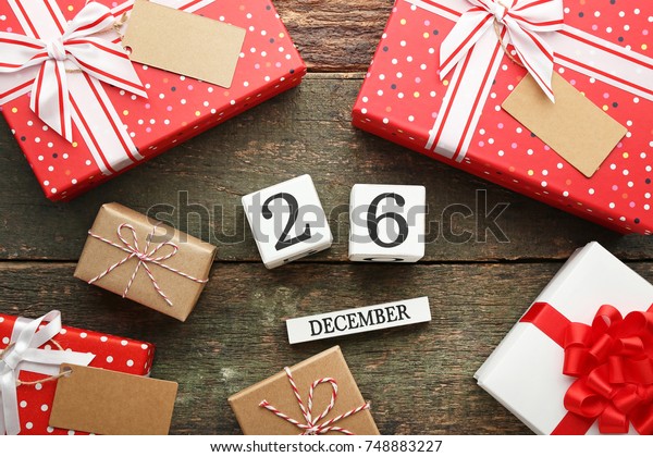 Boxing Day Concept. Different kinds of gift\
boxes on wooden\
background