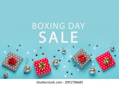 Boxing Day Sale promotion composition background. Christmas Shopping, Offer, Sale Concept. Holiday decorations and festive gift boxes on pastel blue background. Flat lay, top view, copy space.  - Powered by Shutterstock