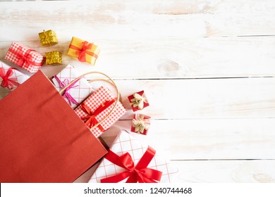 Boxing Day Sale Text On A Black Tag With Shopping Bag And Gift Box On A Wooden White Background. Online Shopping Concept.