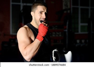 Boxing Fighter Putting On Mouthguard. 