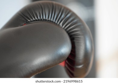 Boxing Glove On Background Of Heavy Bag