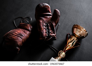 Boxing Gloves With A Cup On A Black Background Top View. Mockup