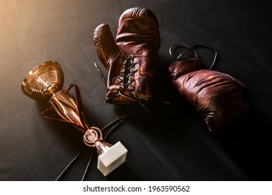 Boxing Gloves With A Cup On A Black Background Top View. Mockup