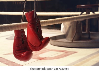 Boxing Gloves Are Hanging On A Rope Of Ring After Training Period