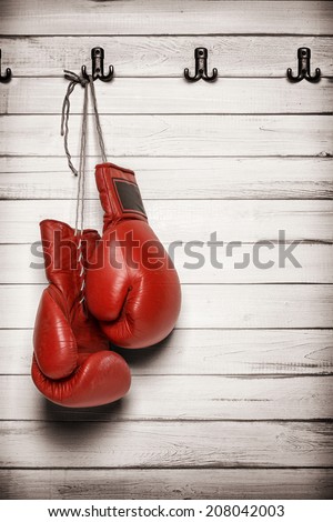 Boxing gloves hanging on wooden wall -including clipping path