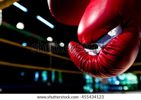 boxing gloves hangs off the boxing ring in a slum camp